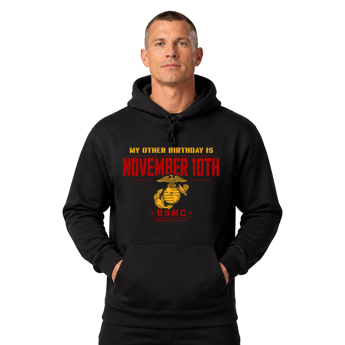 A man wearing a black pullover hoodie with a graphic print that reads 'MY OTHER BIRTHDAY IS NOVEMBER 10TH' in yellow and red, above a gold and red USMC emblem.
